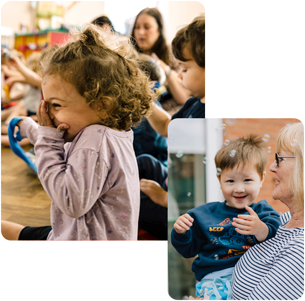 Girls smiling and boy on carers arm looking at bubbles